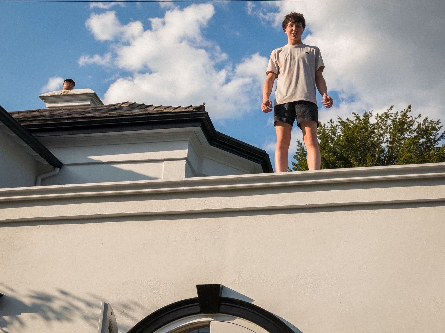 Louis-François Geoffrion standing on a rooftop against a blue summer sky